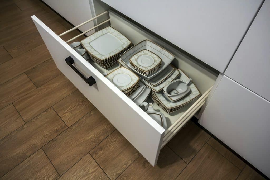 Open kitchen drawer with plates inside, a smart solution for kitchen storage and organizing